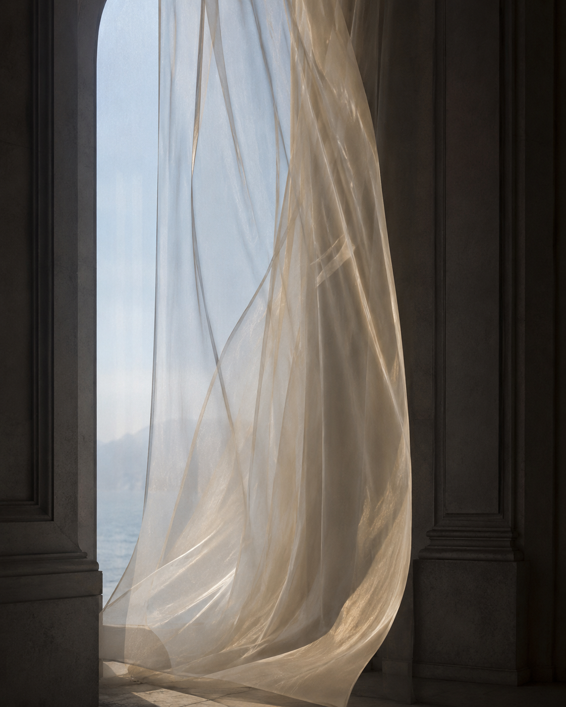 A bedroom at dawn in silk bedding, a sheer curtain lifting at an open window over the sea.